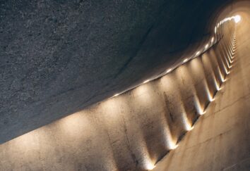 A narrow hallway is lit up by lights